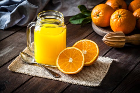 vitamin d foods Orange juice glass jar shot on rustic wooden table