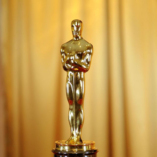 oscars statuette on red cushion
