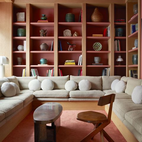 bespoke brushed oak shelves and seating in the library 1970s table and pierre chapo chair from magen h gallery  architectural digest