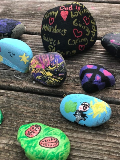 small, smooth hand painted stones with various pictures on them