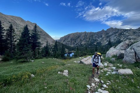The hiker wears and returns outdoor gear