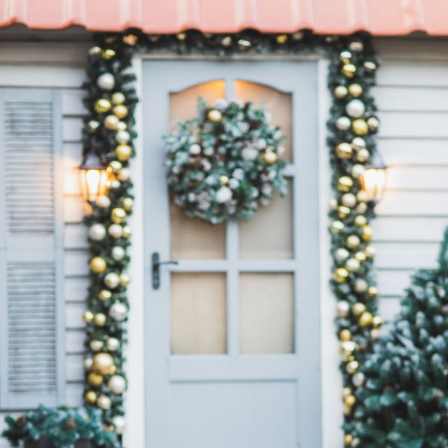 winter rustic entrance door decorated for new year and christmas with ornaments, sled with fir tree and christmas lights winter exterior of a country house with christmas decorations in rustic style christmas eve cozy home decor