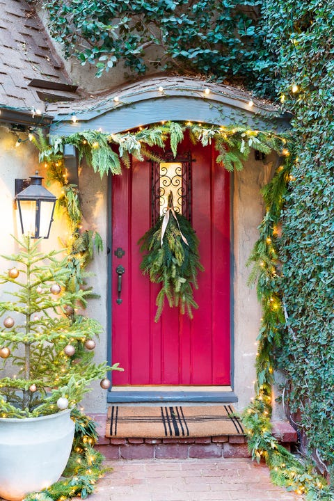 red front door decorated for the holidays