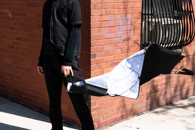 a man holding a flat bag