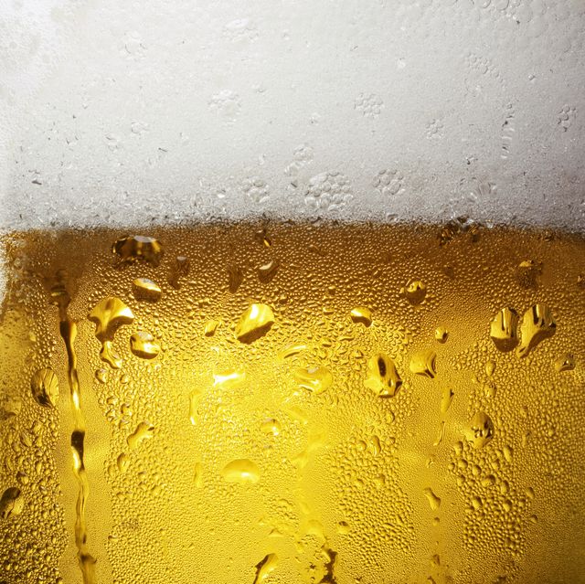 overfull glass of beer with condensation