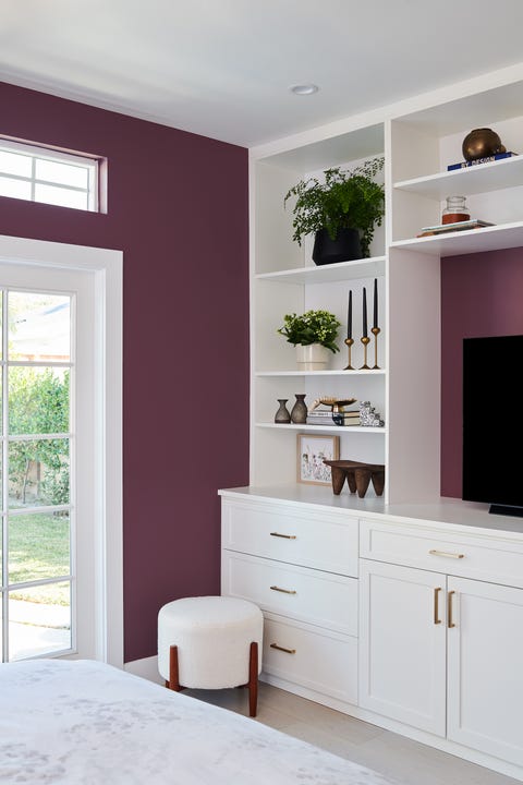 room with purple walls and white cabinet
