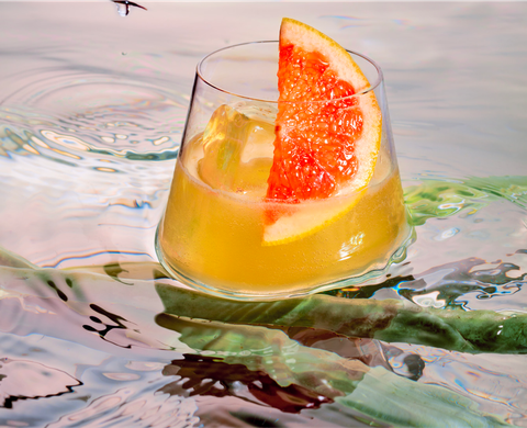 orange cocktail floating in water