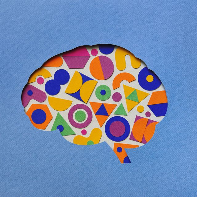 paper brain silhouette with geometric shapes