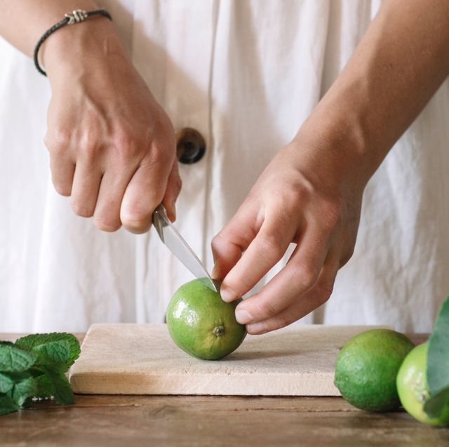 woman slicing lime with paring knife