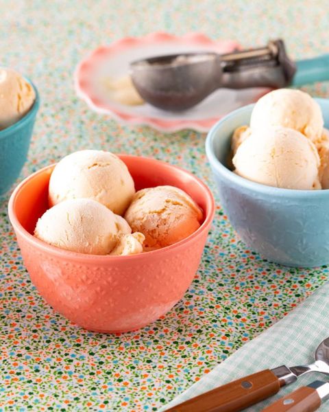 peach ice cream in pink and blue bowls