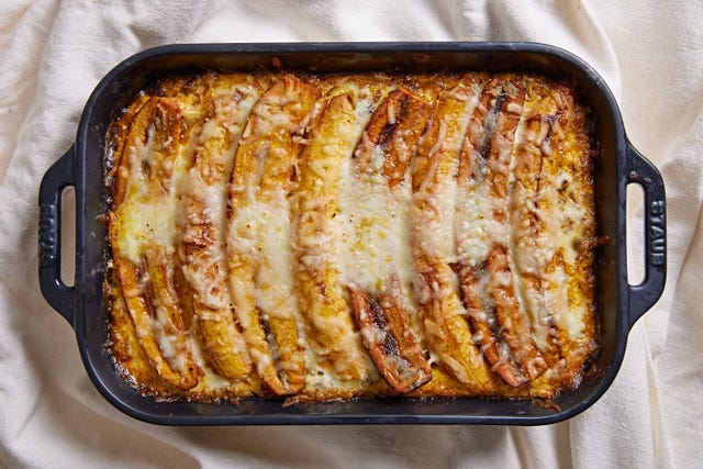 pastelon topped with mozzarella in a black cast iron baking dish