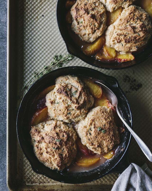 peach cobblers in small cast iron skillets are photographed from the top view