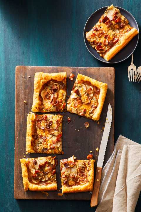 pear, bacon, and blue cheese tart on a wooden slab