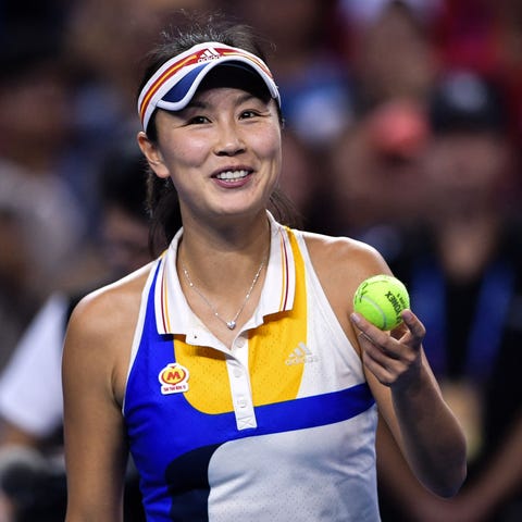 TENNIS-CHN-WTA peng holding a tennis ball