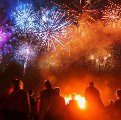 People standing in front of colorful Firework