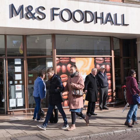 People walking in front of M&S Marks and Spencer Foodhall entrance in Market square, Cambridge, UK