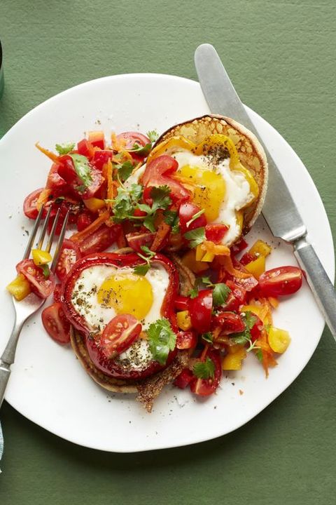 a white plate topped with sauteed chopped peppers and eggs cooked in sliced peppers, eggs are a good housekeeping pick for a healthy weight loss food