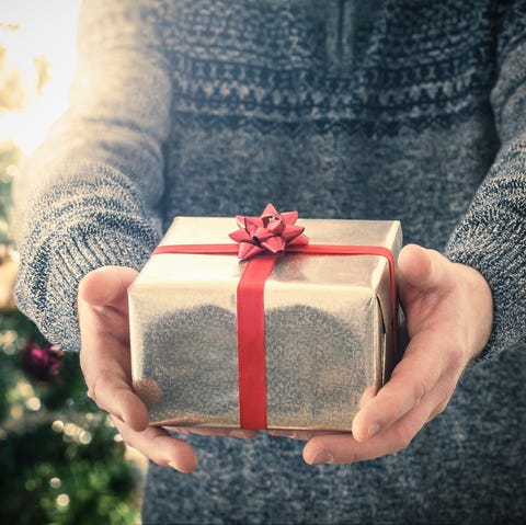 christmas charity- Person holding christmas gift