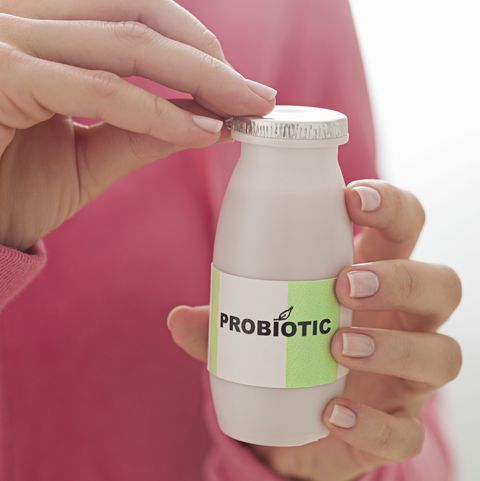 person with bottle of probiotic drink