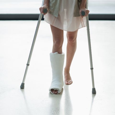 person with cast on leg using crutches