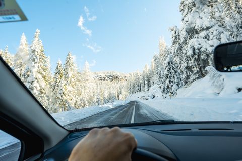 personal perspective of person driving car in snow, dolomites, italy