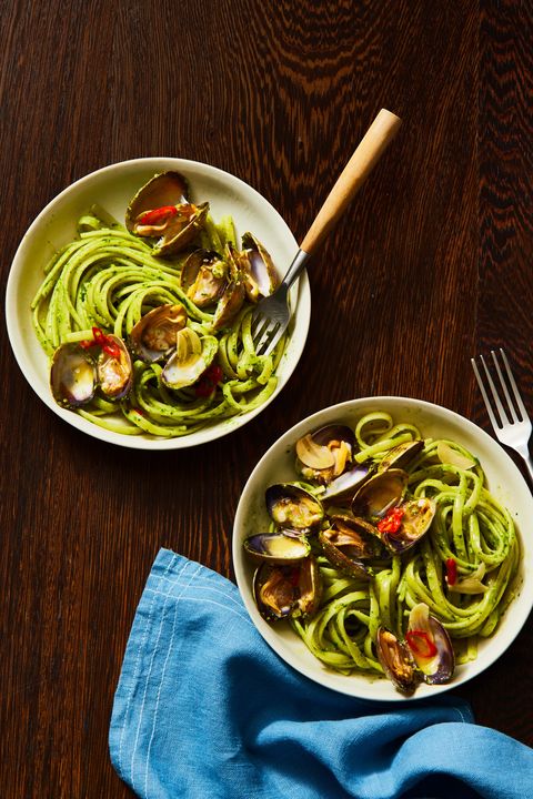 pesto linguine with clams in two bowls