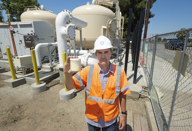 fullerton, ca   july 01 engineer ben smith with the orange county groundwater authority holds an ion exchange resin media at a new water treatment plant along kimberly ave in fullerton, ca the tanks behind smith hold the media that is used to remove pfas, a family of chemicals used for waterproofing and stain proofing among other uses photo by paul bersebachmedianews grouporange county register via getty images