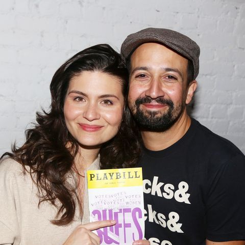 phillipa soo pointing to a suffs playbill while standing next to lin manuel miranda