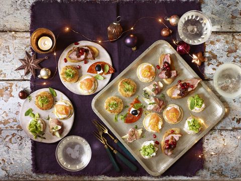 Christmas canapés with fairy lights, candles and decorations  