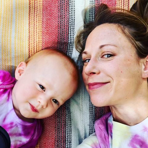 the author laying on a blanket with her daughter