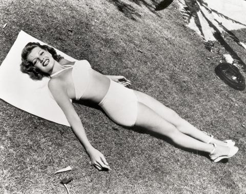 actress rita hayworth lying in the sun