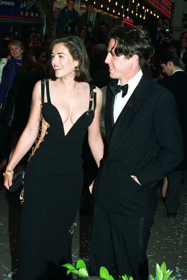 actor hugh grant arrives with actress girlfriend elizabeth hurley for the charity premiere of "four weddings and a funeral" in which he stars   photo by michael stephens   pa imagespa images via getty images