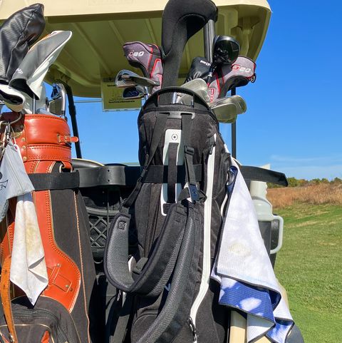 two golf bags on the back of a golf cart