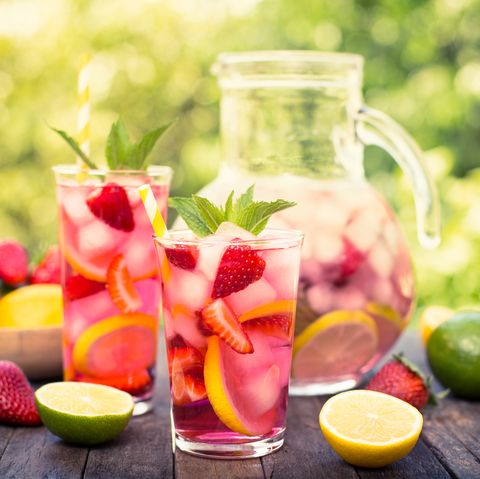 summer activities pink lemonade with lemon, lime and strawberries
