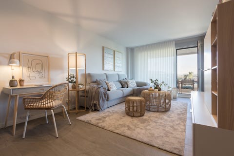 salón con escritorio decorado con tonos neutros y muebles de fibras