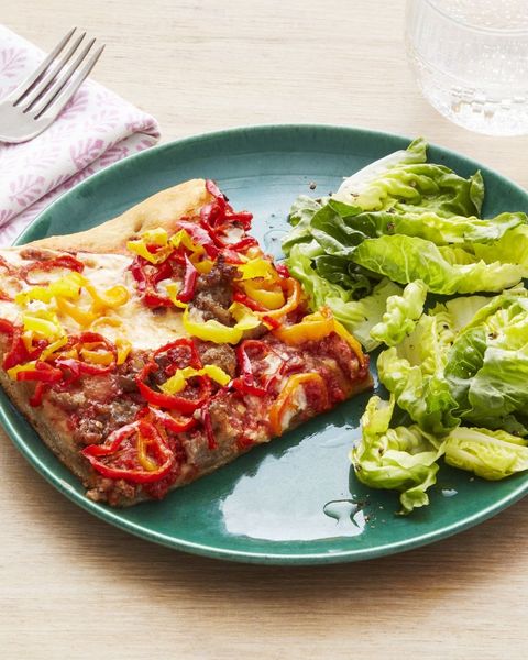 sausage and peppers pizza square slice on plate with salad
