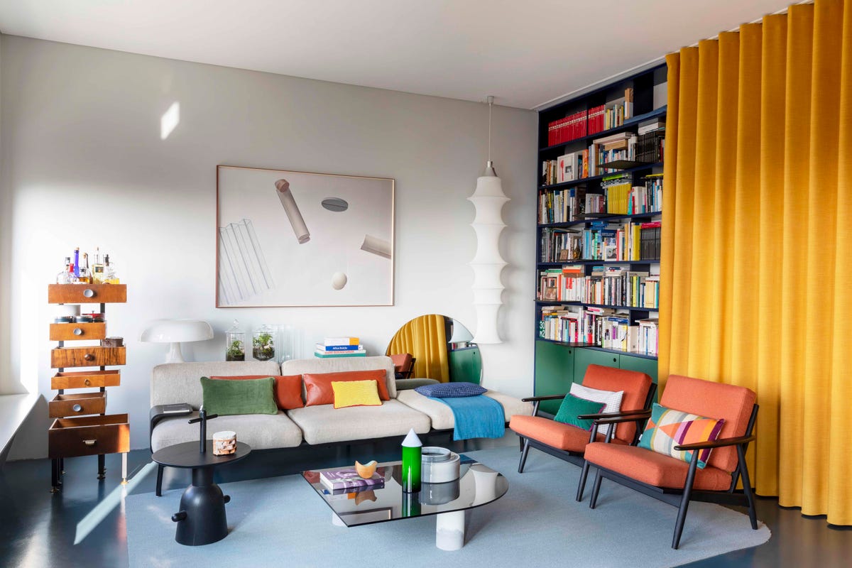 Colourful curtains cleverly divide this Turin home