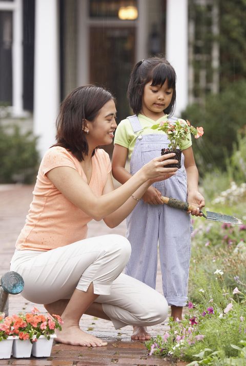 woman and child planting flowers