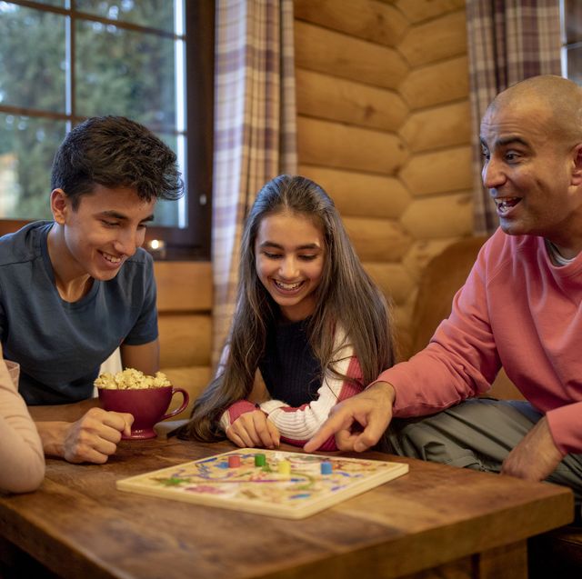 best board games for families 2022  family playing a board game