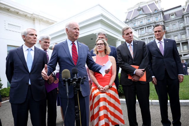 washington, dc   june 24 us president joe biden speaks outside the white house with a bipartisan group of senators after meeting on an infrastructure deal june 24, 2021 in washington, dc from left to right are sen rob portman r oh, sen bill cassidy r la, sen kyrsten sinema d az, sen joe manchin d wv, sen mark warner d va and sen mitt romney r ut  photo by kevin dietschgetty images