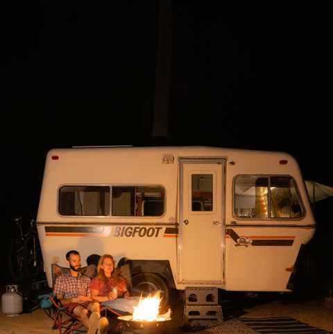 jeff and allie having a campfire in front of the 1981 bigfoot with jeff and allie inside in marana, az on march 3rd, 2022