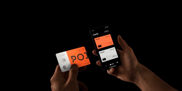left hand holding points card and right hand holding phone using points app