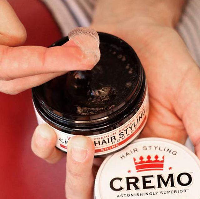 person using cremo pomade