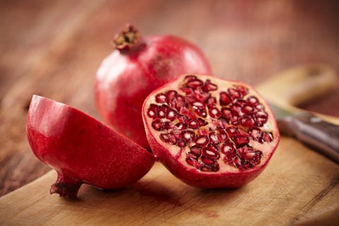 Pomegranate fruit on cut board