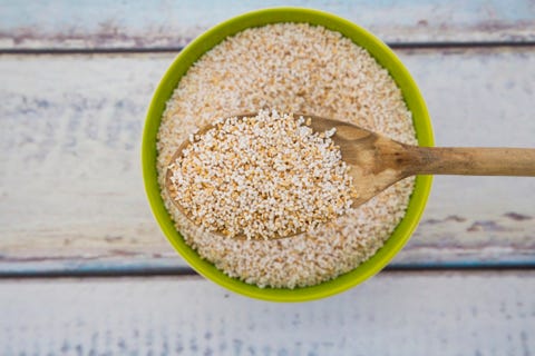 popped organic amarant on wood spoon and in bowl