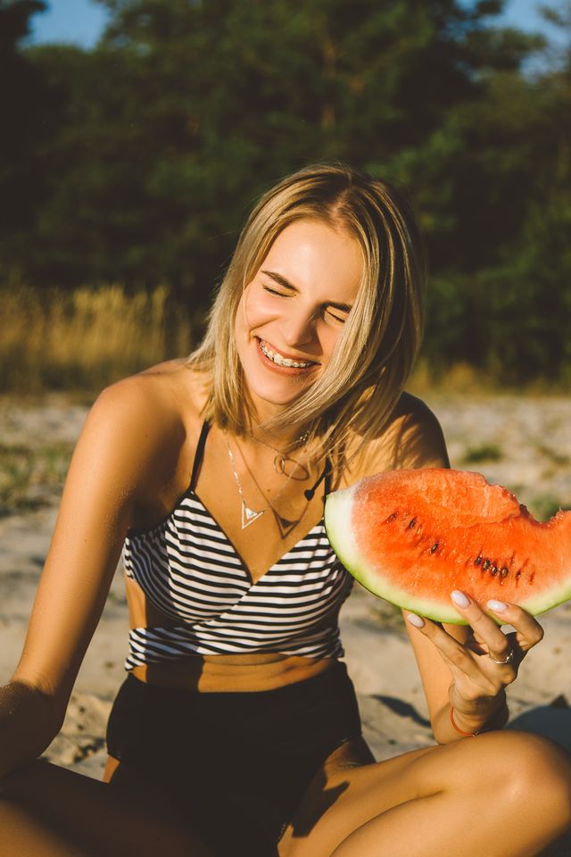 portrait of a beautiful young woman eating watermelon