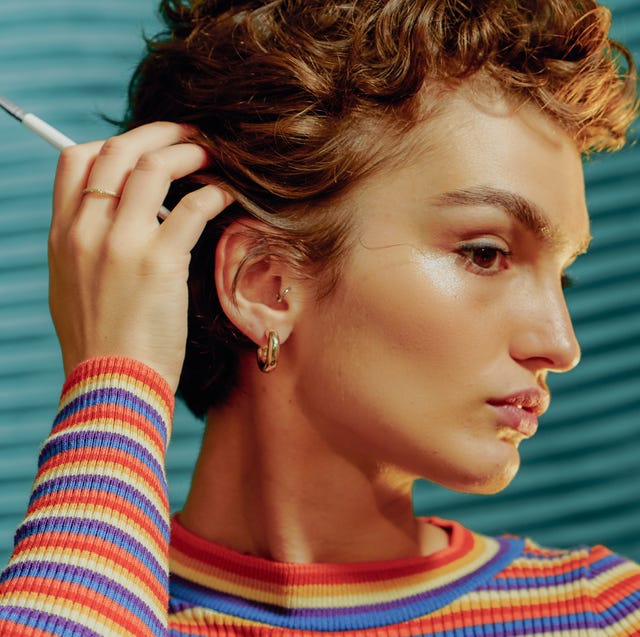 Portrait of a Young Confident Woman Touching her Hair Portrait of a Young Confident Woman Touching her Hair