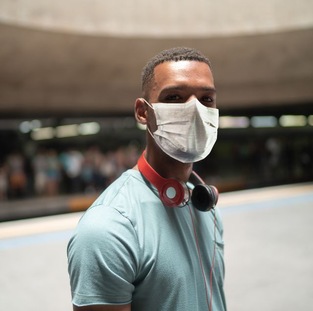 portrait of a young man using protective mask at metro station