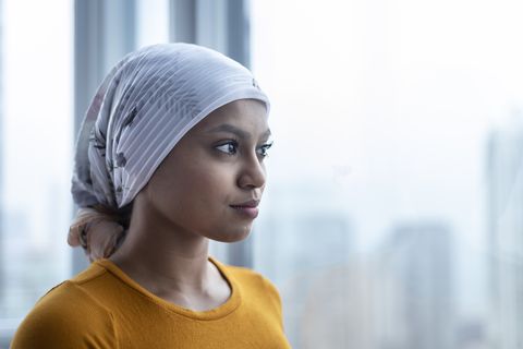 Portrait of beautiful young ethnic woman with cancer