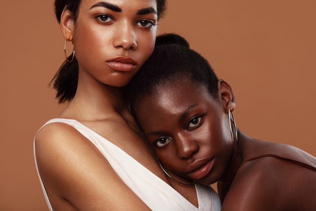 portrait of females against brown background